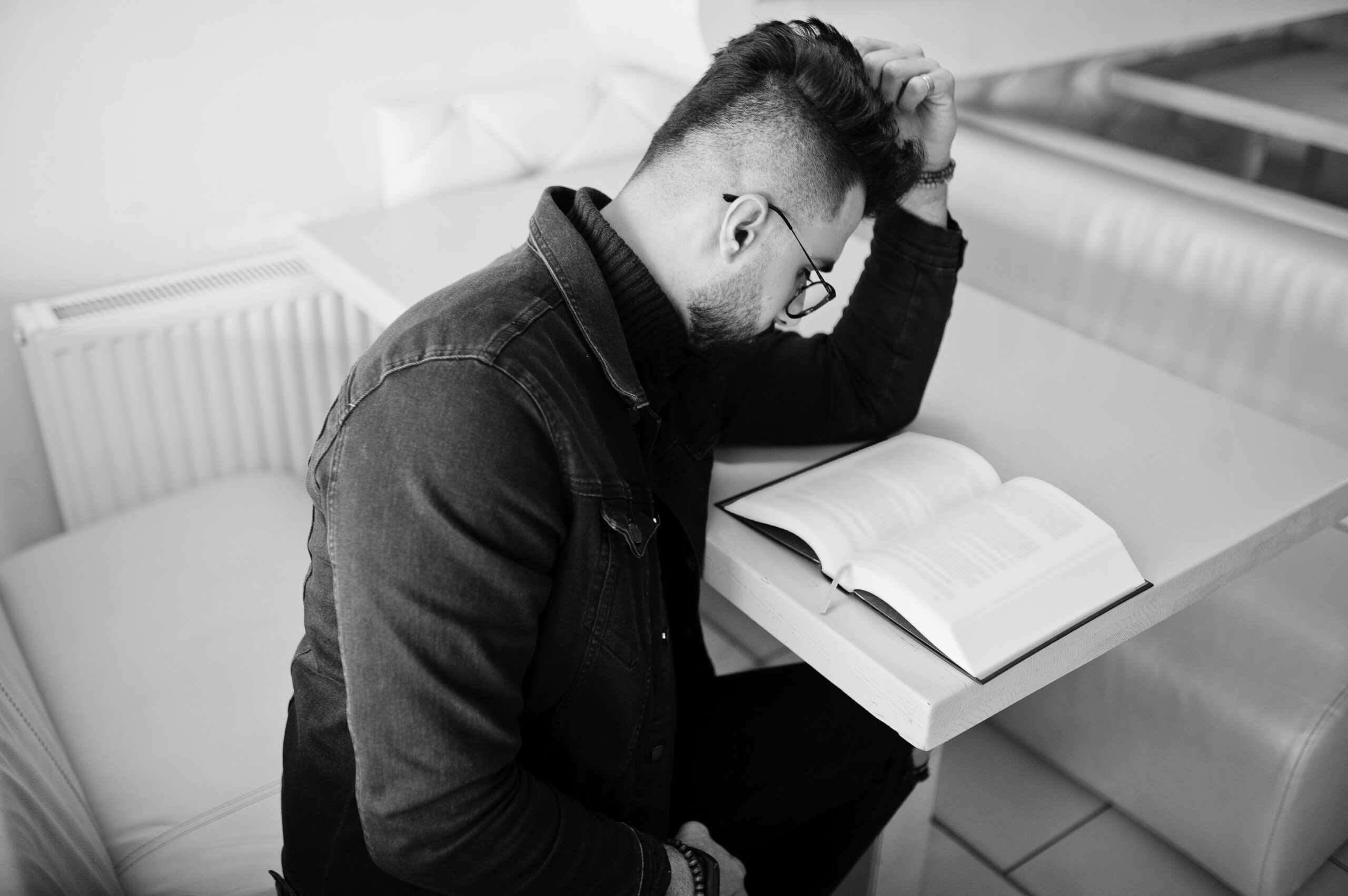 arab man wear on black jeans jacket and eyeglasses sitting in ca